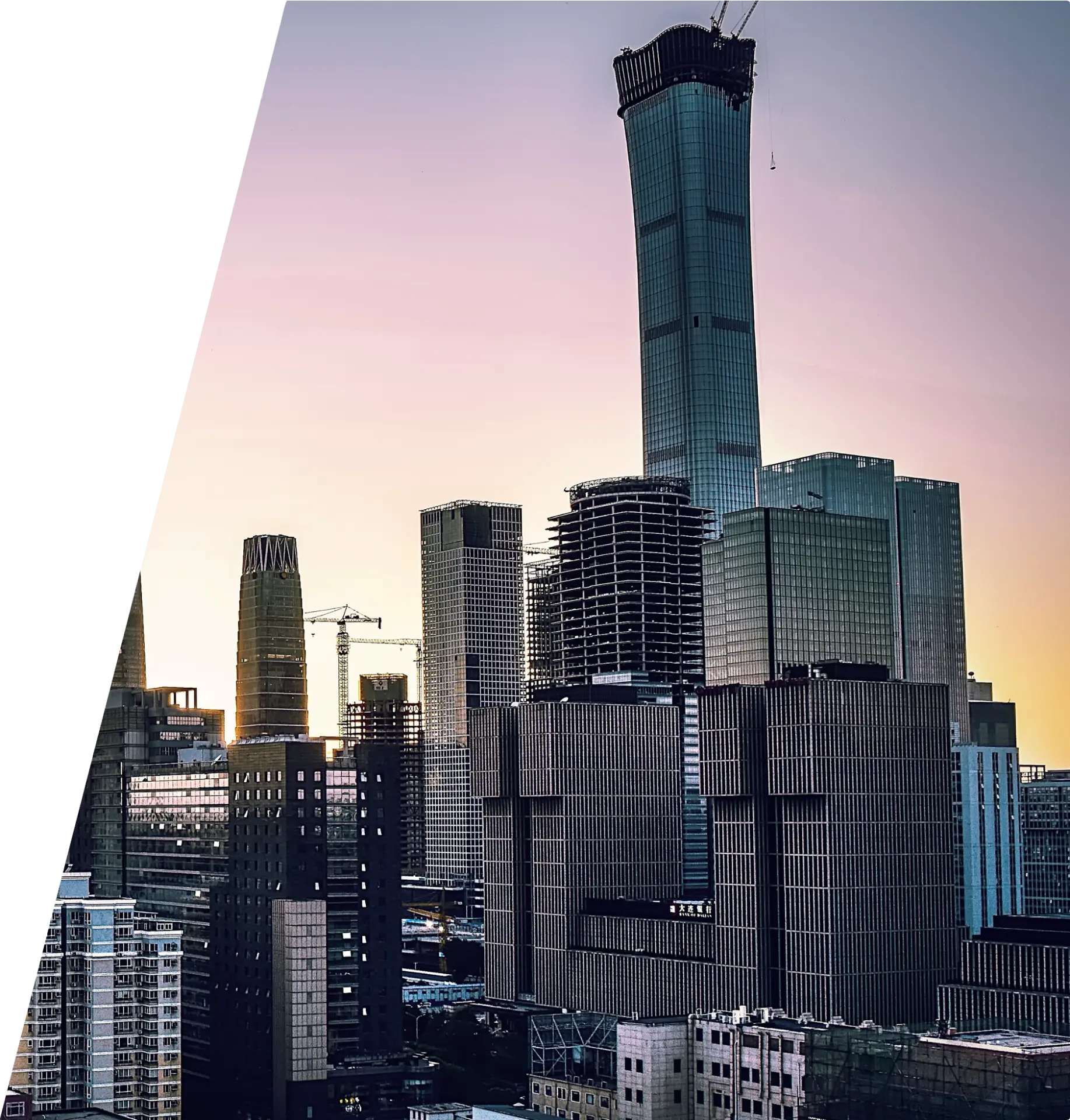 Dusk city skyline with high-rise towers under construction