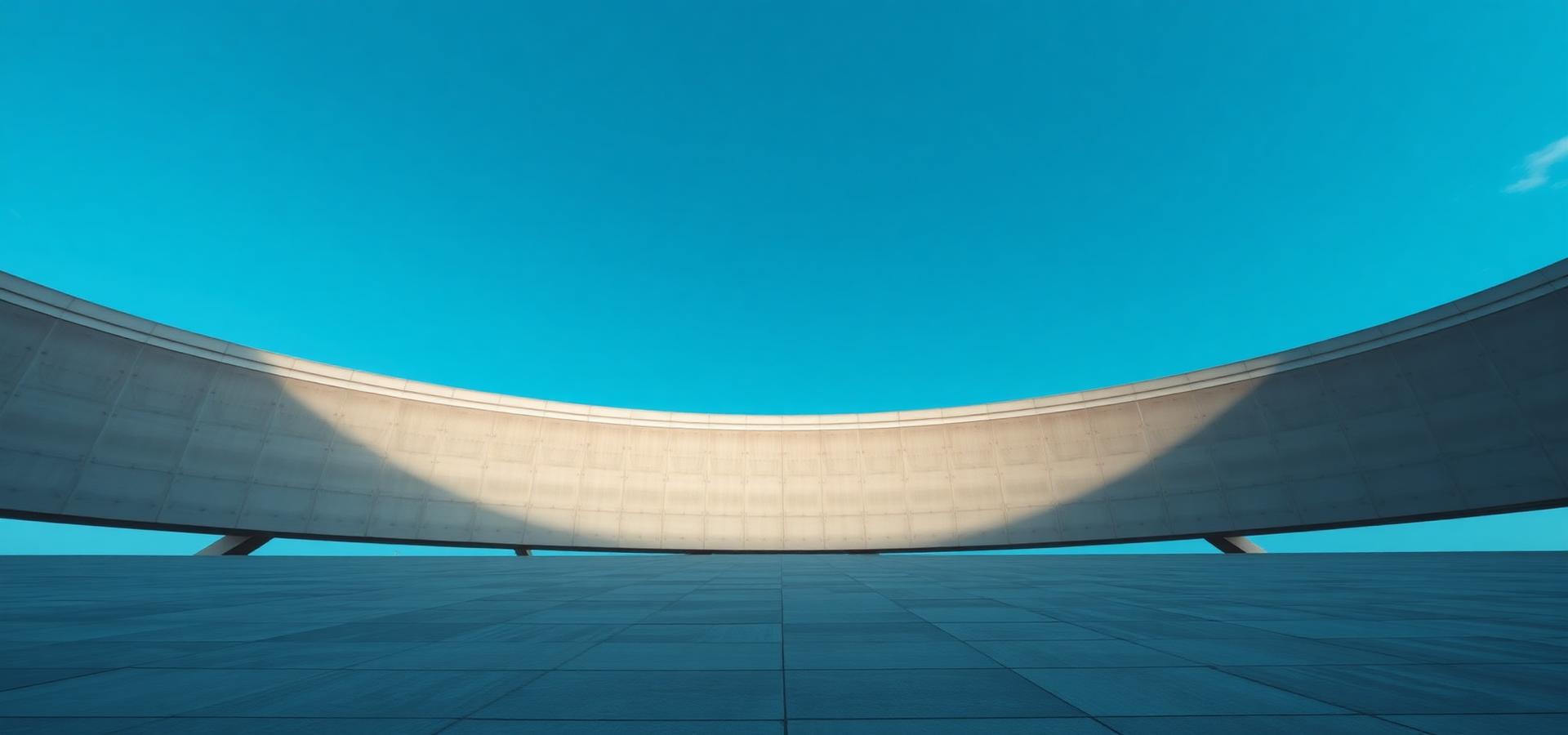 Sweeping curved concrete structure against a clear sky